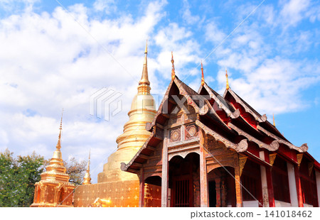 Golden stupa and wooden pavilion in Wat Chedi Luang Temple complex, Chiang Mai, Thailand. Wat Chedi Luang is a Buddhist temple in historic center of Chiang Mai. Topic of vacation, travel, trip, tour Golden stupa and wooden pavilion in Wat Chedi Luang Temple complex, Chiang Mai, Thailand. Wat Chedi Luang is a Buddhist temple in historic center of Chiang Mai. Topic of vacation, travel, trip, tour 141018462