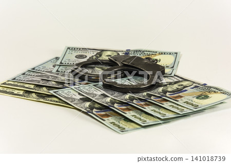 Metal handcuffs on banknotes US dollars Metal handcuffs on banknotes US dollars 141018739