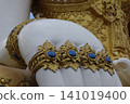 Gold statue white sculpture ornate decoration blue gem close up temple art religious symbol carved detail decorative pattern traditional style 141019400