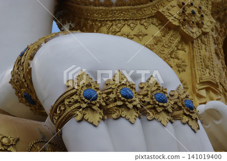Gold statue white sculpture ornate decoration blue gem close up temple art religious symbol carved detail decorative pattern traditional style Gold statue white sculpture ornate decoration blue gem close up temple art religious symbol carved detail decorative pattern traditional style 141019400