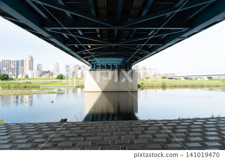 The silhouette of the bridge reflected on the river surface | Reflection of a bridge on the Tama River in the early morning - June The silhouette of the bridge reflected on the river surface | Reflection of a bridge on the Tama River in the early morning - June 141019470
