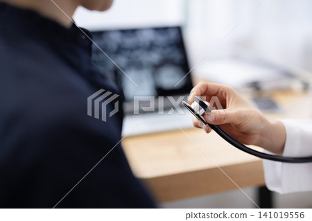 Close-up of a stethoscope held by a female doctor. Close-up of a stethoscope held by a female doctor. 141019556