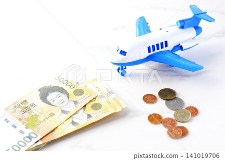 Image of departing for a trip to Korea with Korean won (KRW) banknotes and an airplane Image of departing for a trip to Korea with Korean won (KRW) banknotes and an airplane 141019706