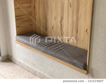 Built in wooden bench niche with gray cushion in modern interior design Built in wooden bench niche with gray cushion in modern interior design 141019897
