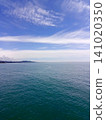 Sea waves crashing on the rocky shore with white foam on a sunny day. 141020350
