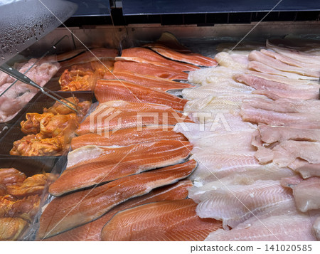 Fresh Salmon Fillets And White Fish Displayed At Market Seafood Counter Fresh Salmon Fillets And White Fish Displayed At Market Seafood Counter 141020585