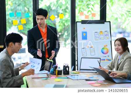 Developer and UX UI Designer Team Discussing Mobile App Design in Modern Office Meeting 141020655