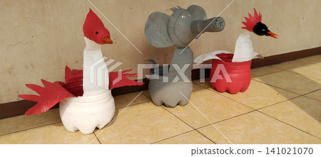 Handmade plant pots made from recycled plastic bottles, painted and shaped to resemble unique birds and an elephant. Handmade plant pots made from recycled plastic bottles, painted and shaped to resemble unique birds and an elephant. 141021070