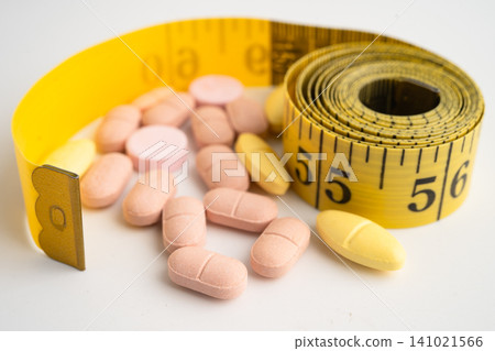 Measuring tape and tablet drug medical for diet. Measuring tape and tablet drug medical for diet. 141021566