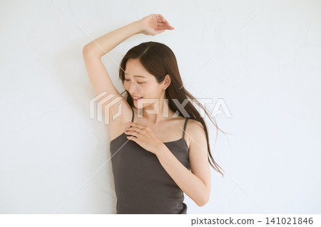 A beauty/hair removal image of a woman smiling and showing her armpits. A beauty/hair removal image of a woman smiling and showing her armpits. 141021846