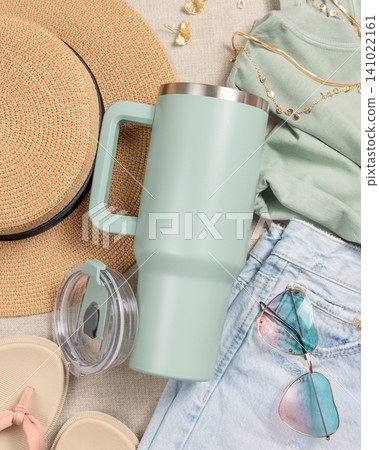 Blank sage green 40oz tumbler mockup, stainless steel travel thermos on denim and dark red sweatshirt Blank sage green 40oz tumbler mockup, stainless steel travel thermos on denim and dark red sweatshirt 141022161