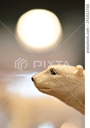 A miniature polar bear and a round light fixture A miniature polar bear and a round light fixture 141022388