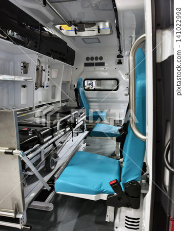 Ambulance interior shows space with seats and medical equipment for emergency response and patient care Ambulance interior shows space with seats and medical equipment for emergency response and patient care 141022998