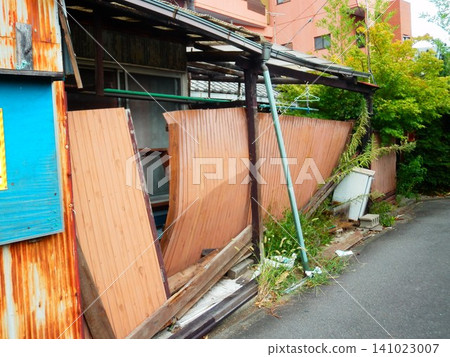 Broken corrugated iron roof of an old house Broken corrugated iron roof of an old house 141023007