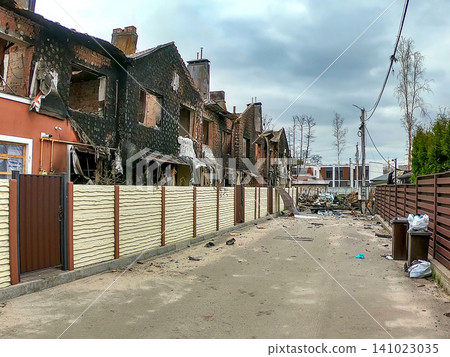 Destruction seen on a street with burned buildings in a neighborhood after a recent fire incident in the area Destruction seen on a street with burned buildings in a neighborhood after a recent fire incident in the area 141023035