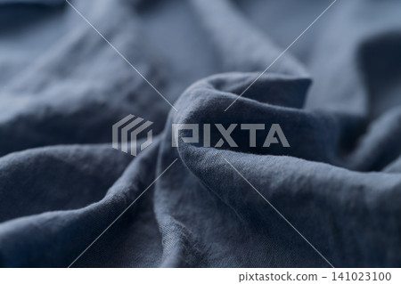 Closeup photo of blue linen fabric for clothing Closeup photo of blue linen fabric for clothing 141023100