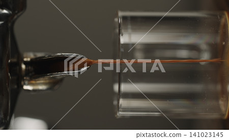 pour espresso in glass closeup pour espresso in glass closeup 141023145