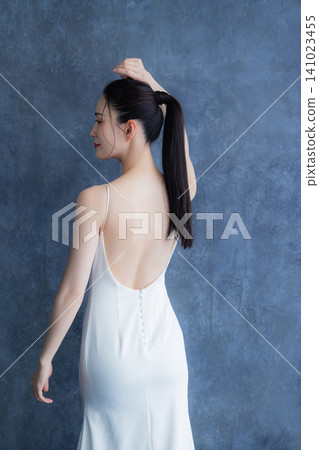A woman in a white dress A woman in a white dress 141023455