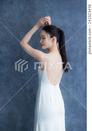 A woman in a white dress A woman in a white dress 141023456