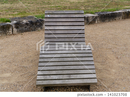 Wooden sun lounger on beach 141023708