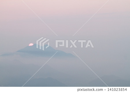 The morning sun rising from the hazy mountains The morning sun rising from the hazy mountains 141023854