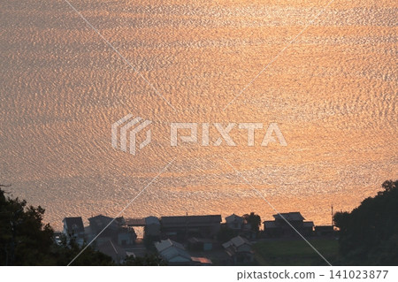 The sea illuminated by the sunset The sea illuminated by the sunset 141023877