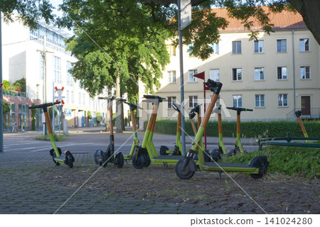 Electric scooters parked on a city street Electric scooters parked on a city street 141024280