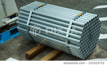 Bundle of galvanized steel pipes on wooden supports Bundle of galvanized steel pipes on wooden supports 141024732