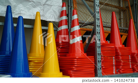 Colorful traffic cones in stacks at an industrial warehouse Colorful traffic cones in stacks at an industrial warehouse 141024738