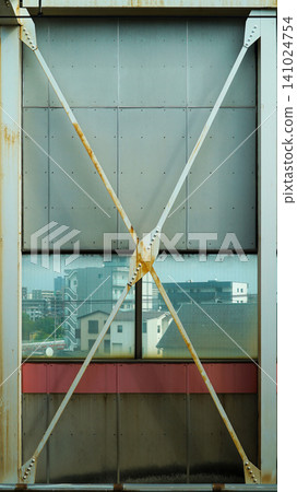 Industrial steel X bracing structure on a platform wall inside a Japanese subway station Industrial steel X bracing structure on a platform wall inside a Japanese subway station 141024754