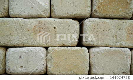 Neat stack of cream colored rectangle adobe bricks Neat stack of cream colored rectangle adobe bricks 141024758