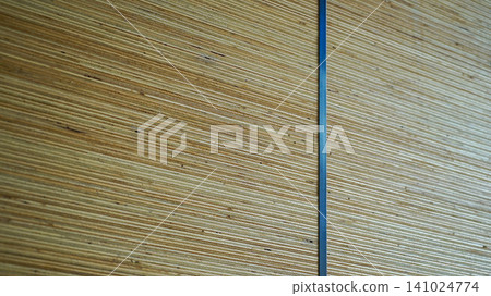 Side view profile of stacked plywood sheets bound with a plastic strap Side view profile of stacked plywood sheets bound with a plastic strap 141024774