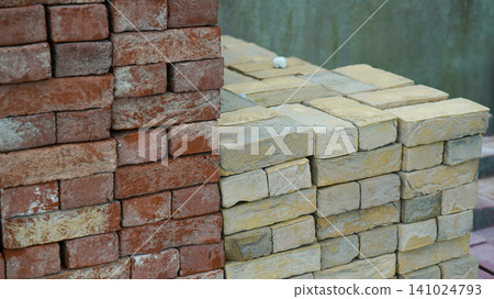 Stacked red and yellow clay bricks at a construction yard Stacked red and yellow clay bricks at a construction yard 141024793