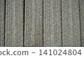 Textured grey concrete wall panels with vertical grooves 141024804