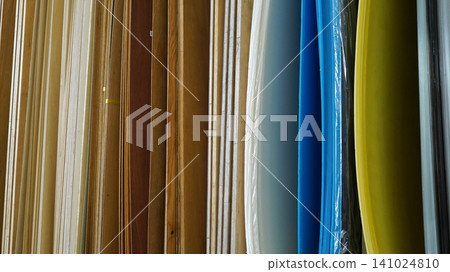 Vertical samples of wooden veneers and colorful plastic sheets Vertical samples of wooden veneers and colorful plastic sheets 141024810