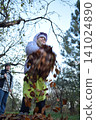 Young father, pre-teen daughter and son in warm autumn clothes spending quality time together among fallen leaves. Happy family enjoying the beauty of fall, playful moments and family life outdoors 141024890