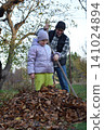 Young father, pre-teen daughter and son in warm autumn clothes spending quality time together among fallen leaves. Happy family enjoying the beauty of fall, playful moments and family life outdoors 141024894
