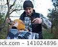 Young father, pre-teen daughter and son in warm autumn clothes spending quality time together among fallen leaves. Happy family enjoying the beauty of fall, playful moments and family life outdoors 141024896