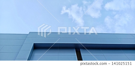 Blue building facade against a clear sky Blue building facade against a clear sky 141025151