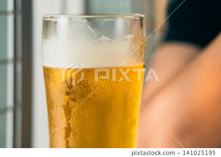 Half-drunk glass of beer Half-drunk glass of beer 141025195