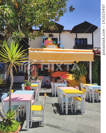 Colorful outdoor cafe with pastel tables in Kas Turkey Colorful outdoor cafe with pastel tables in Kas Turkey 141025497