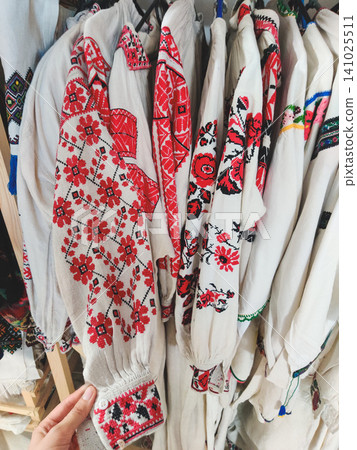 Traditional Ukrainian embroidered shirts (Vyshyvankas) on a clothing rack 141025511