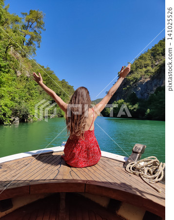 beautiful girl on the deck of a boat while traveling on the sea with a view of the mountains beautiful girl on the deck of a boat while traveling on the sea with a view of the mountains 141025526