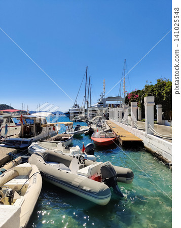 beautiful ships and boats are moored near the shore beautiful ships and boats are moored near the shore 141025548