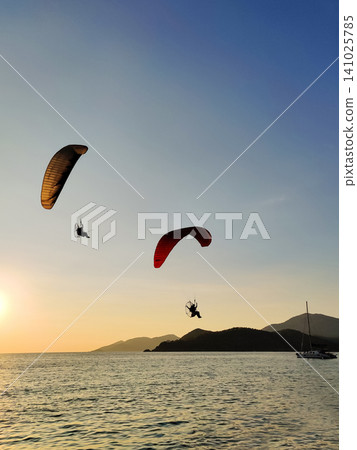 beautiful landscape with a view of the sea flying on a paraglider beautiful landscape with a view of the sea flying on a paraglider 141025785