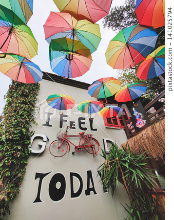 Creative wall decor with rainbow umbrellas and a red vintage bicycle Creative wall decor with rainbow umbrellas and a red vintage bicycle 141025794