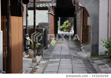 A streetscape with cobblestone alleys between old Japanese houses. A streetscape with cobblestone alleys between old Japanese houses. 141026298