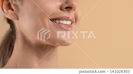 Closeup of young beautiful womans glossy lips, white teeth and smooth skin Closeup of young beautiful womans glossy lips, white teeth and smooth skin 141026303