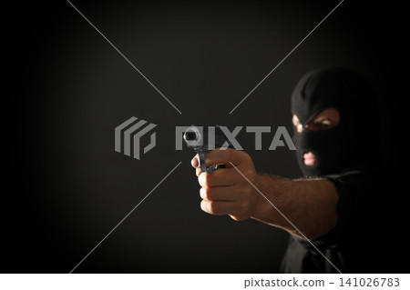 Professional killer on black background, focus on gun. Space for text Professional killer on black background, focus on gun. Space for text 141026783