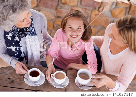 Portrait, women or girl to relax, family or tea to share, wisdom or visit as bonding together. Grandma, mother or female child as smile, drink or retirement at outdoor coffee shop or park table Portrait, women or girl to relax, family or tea to share, wisdom or visit as bonding together. Grandma, mother or female child as smile, drink or retirement at outdoor coffee shop or park table 141027117